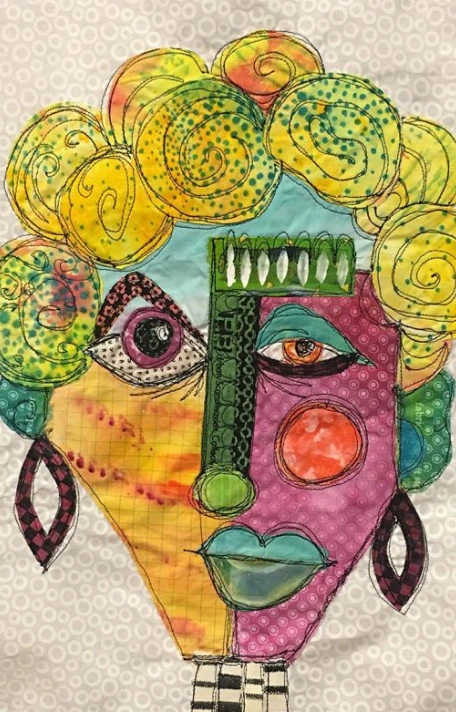 An abstract face made from quilt pieces